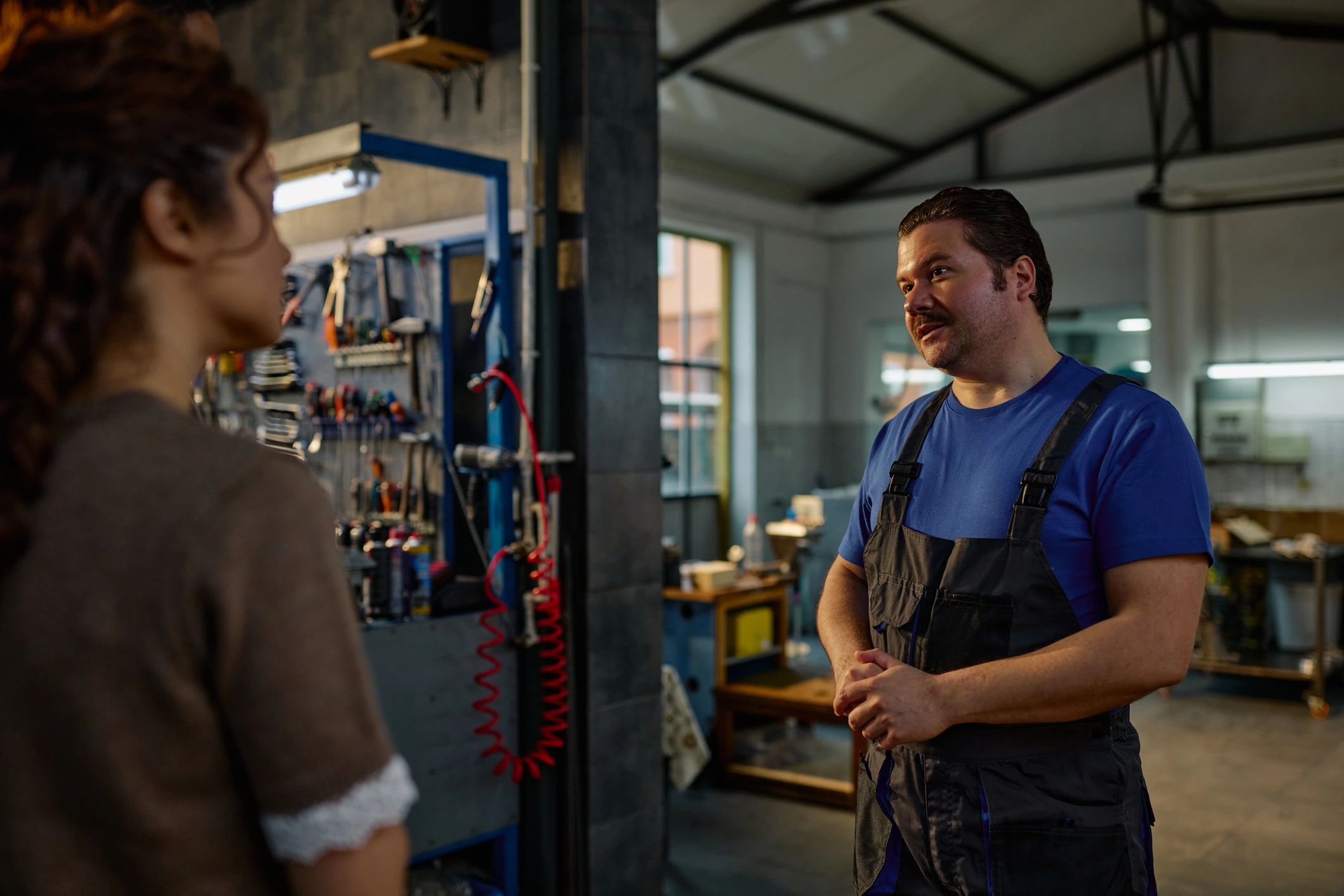 Customer speaking with an auto mechanic about vehicle service